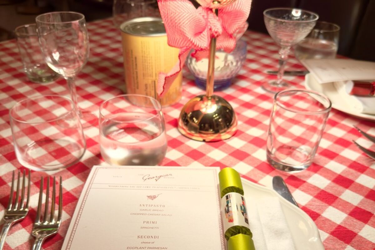 Table setting in the restaurant with menu and checkered tablecloths.