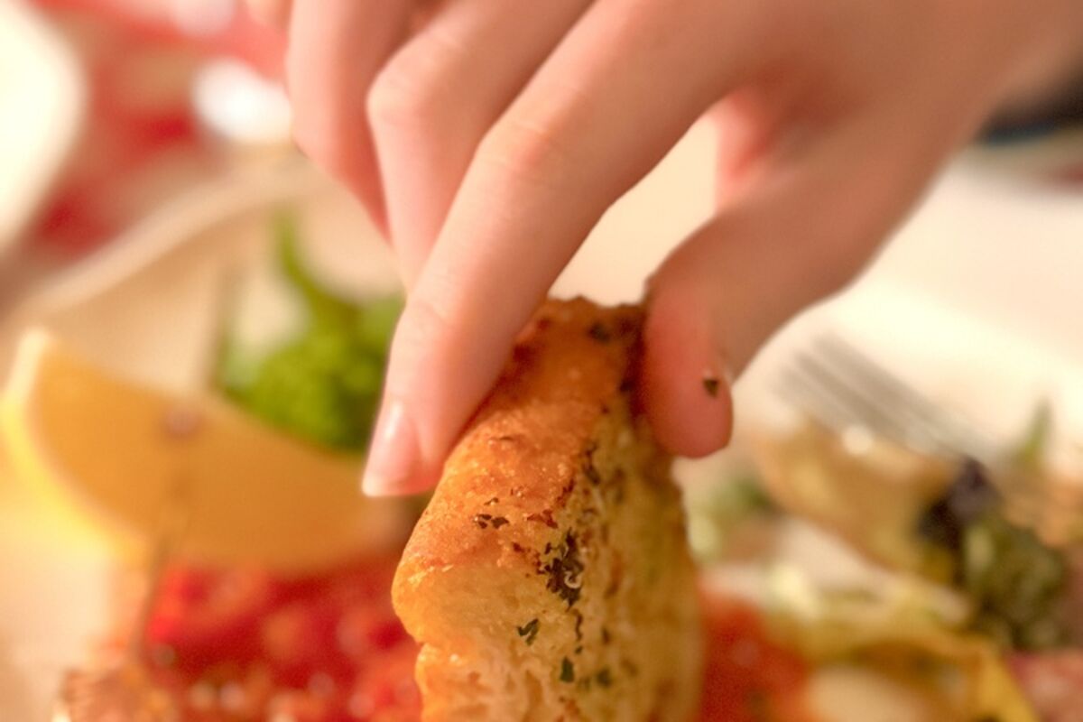 Dipping crusty garlic bread into marinara sauce at The Georgian Room