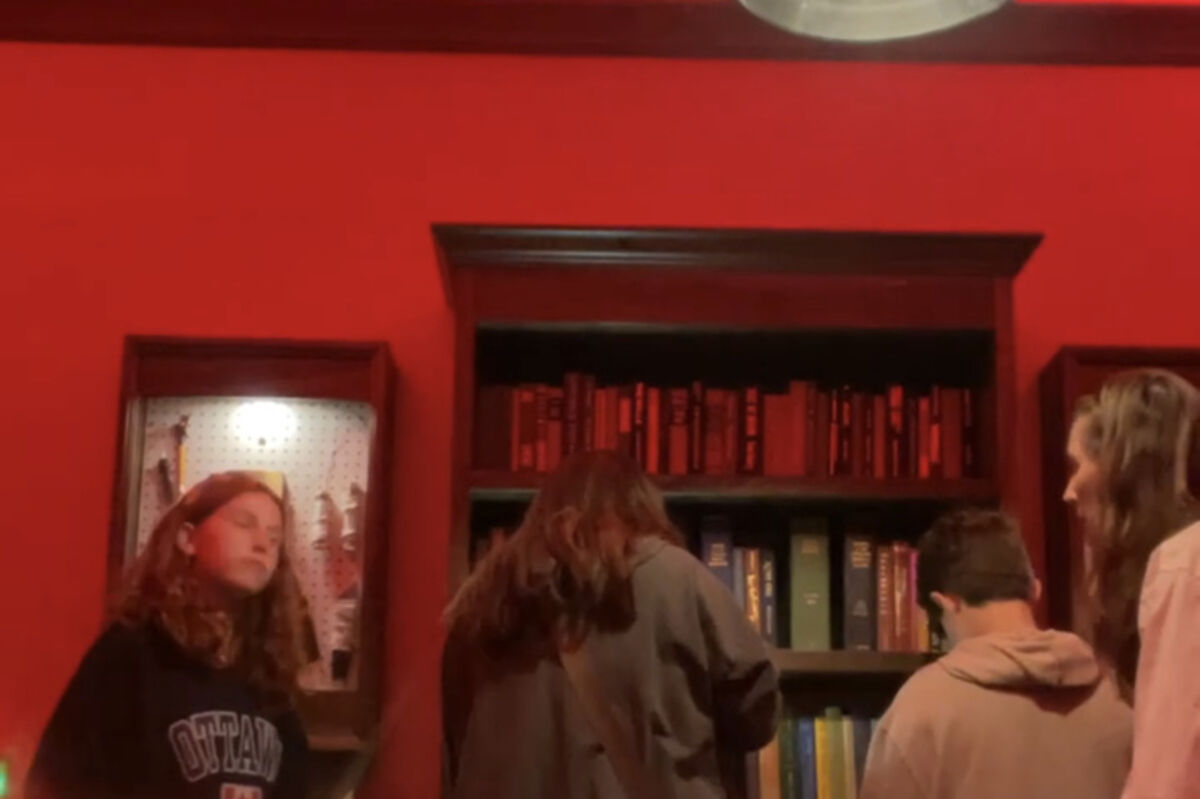 Four people in an escape room looking for clues.