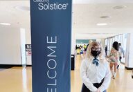 Woman next to a sign Welcome to the Celebrity Solstice Cruise